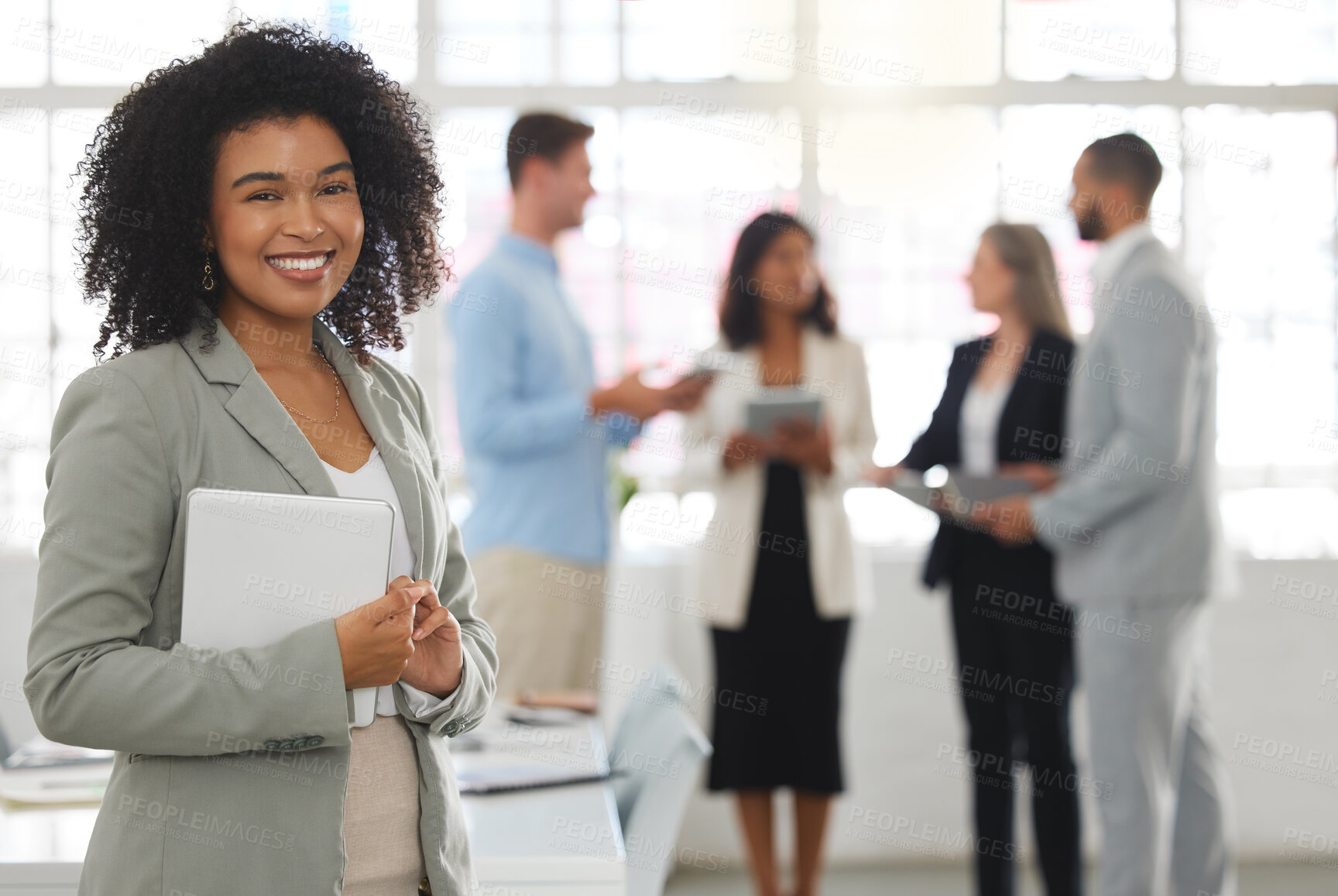Buy stock photo Young happy mixed race businesswoman standing in an office. One confident hispanic female boss with a curly afro smiling and standing while in a meeting at work