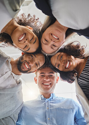 Buy stock photo Group of joyful diverse businesspeople huddling together in support and unity together at work. Happy business professionals joining their heads in a meeting