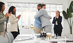 Happy businessmen hugging each other in support and unity while colleagues clap hands in a meeting at work. Diverse group of cheerful businesspeople welcoming an employee to their workplace together