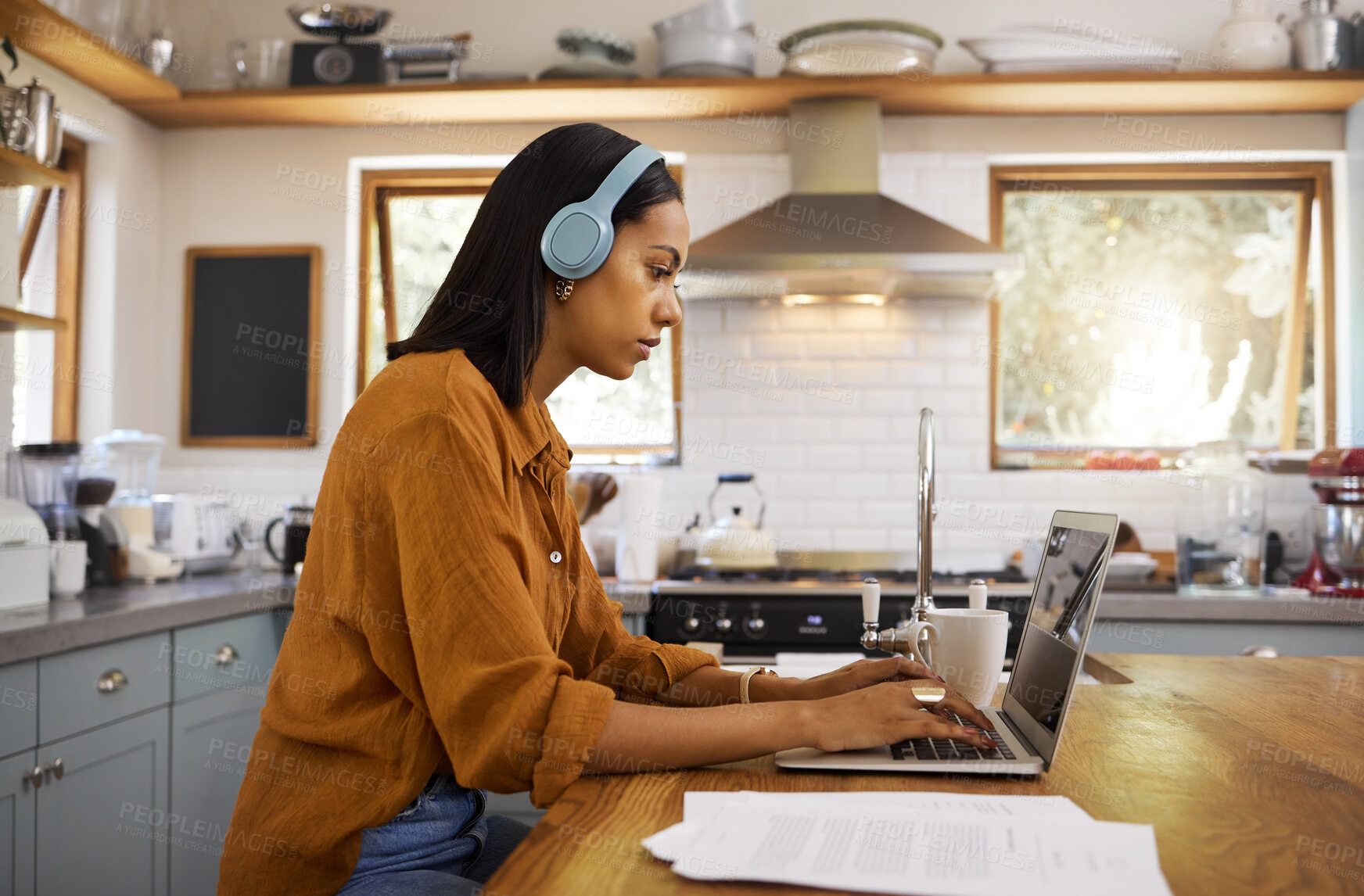 Buy stock photo Laptop, remote work and a woman with focus music, typing email and working on a proposal. Serious, headphones and a freelance worker with a computer for home business, budget and finances online