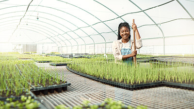 Buy stock photo Portrait of a happy farmer in her garden. African american farmer in a greenhouse. Smiling farmer standing in a nursery. farmer standing in a sustainable farm. Young woman working on a farm