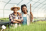 African american farmers working together.Portrait of two women working in a greenhouse. Happy farmers working together. Young women working in agriculture. Colleagues working together.