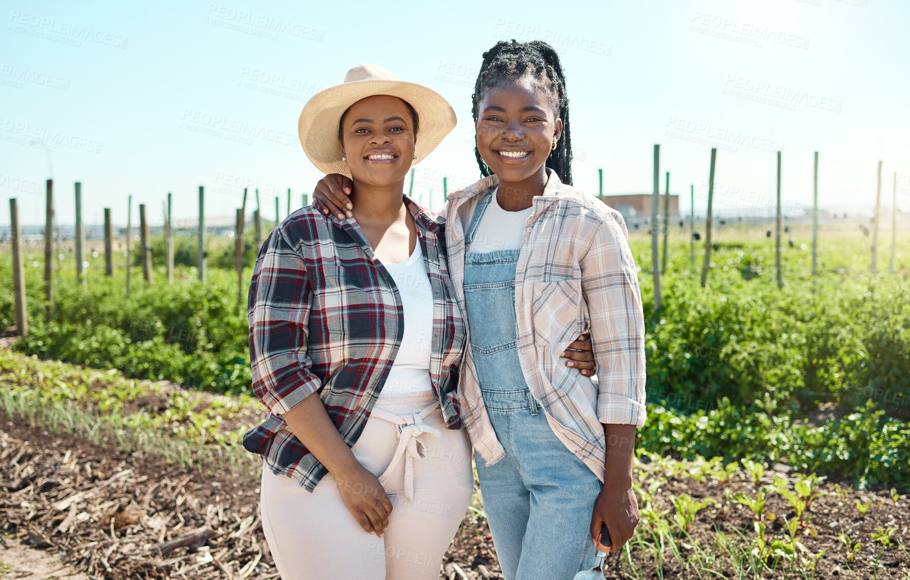 Buy stock photo Young women working on a farm. Portrait of young farmers hugging. Women standing in a garden. Happy farm employees standing on a farm. Farmers being affectionate.