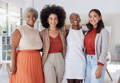Portrait of a diverse group of smiling ethnic business women standing together in the office. Ambitious happy confident professional team of colleagues embracing while feeling supported and empowered