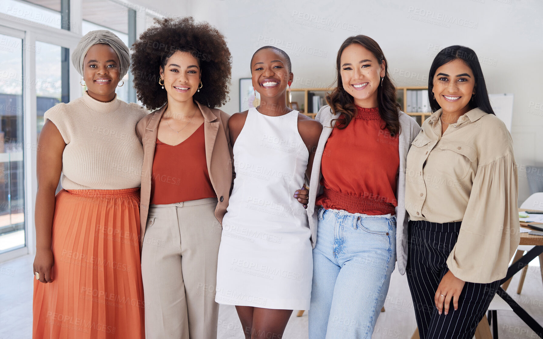 Buy stock photo Portrait of a diverse group of smiling ethnic business women standing together in the office. Ambitious happy confident professional team of colleagues embracing while feeling supported and empowered