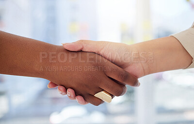 Closeup of two unknown business women shaking hands in office after meeting in boardroom. Ambitious professional colleagues using handshake and hand gesture to congratulate success and welcome to team