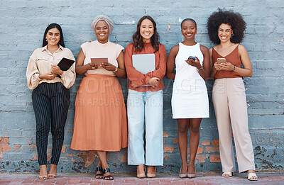 Buy stock photo Portrait, group and business women smile on brick wall with devices or gadgets in city. Technology, cooperation and teamwork, diversity or collaboration of friends, people or employees with happiness