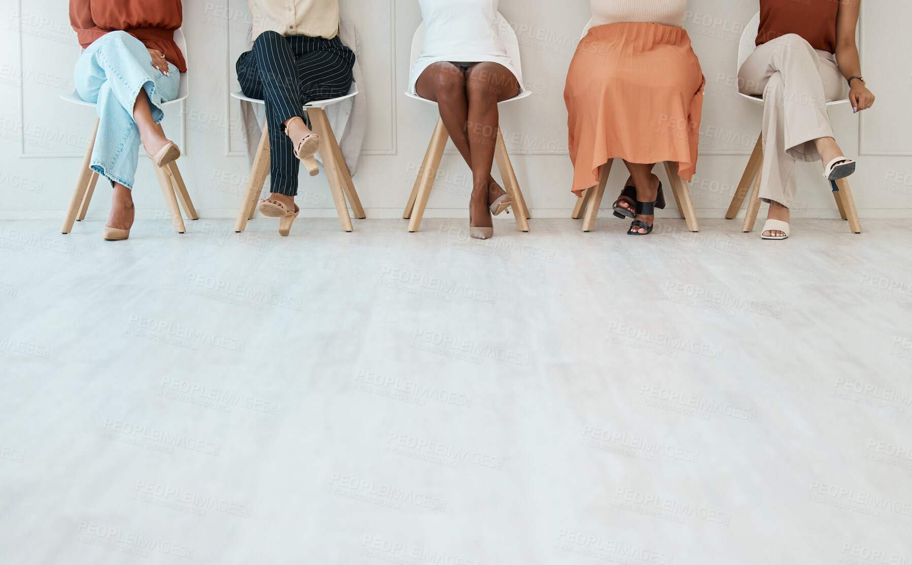 Buy stock photo Feet, interview and business women waiting in line for their meeting with human resources during recruitment. Legs, hiring and candidate with a group of people sitting in a row at an agency for hr