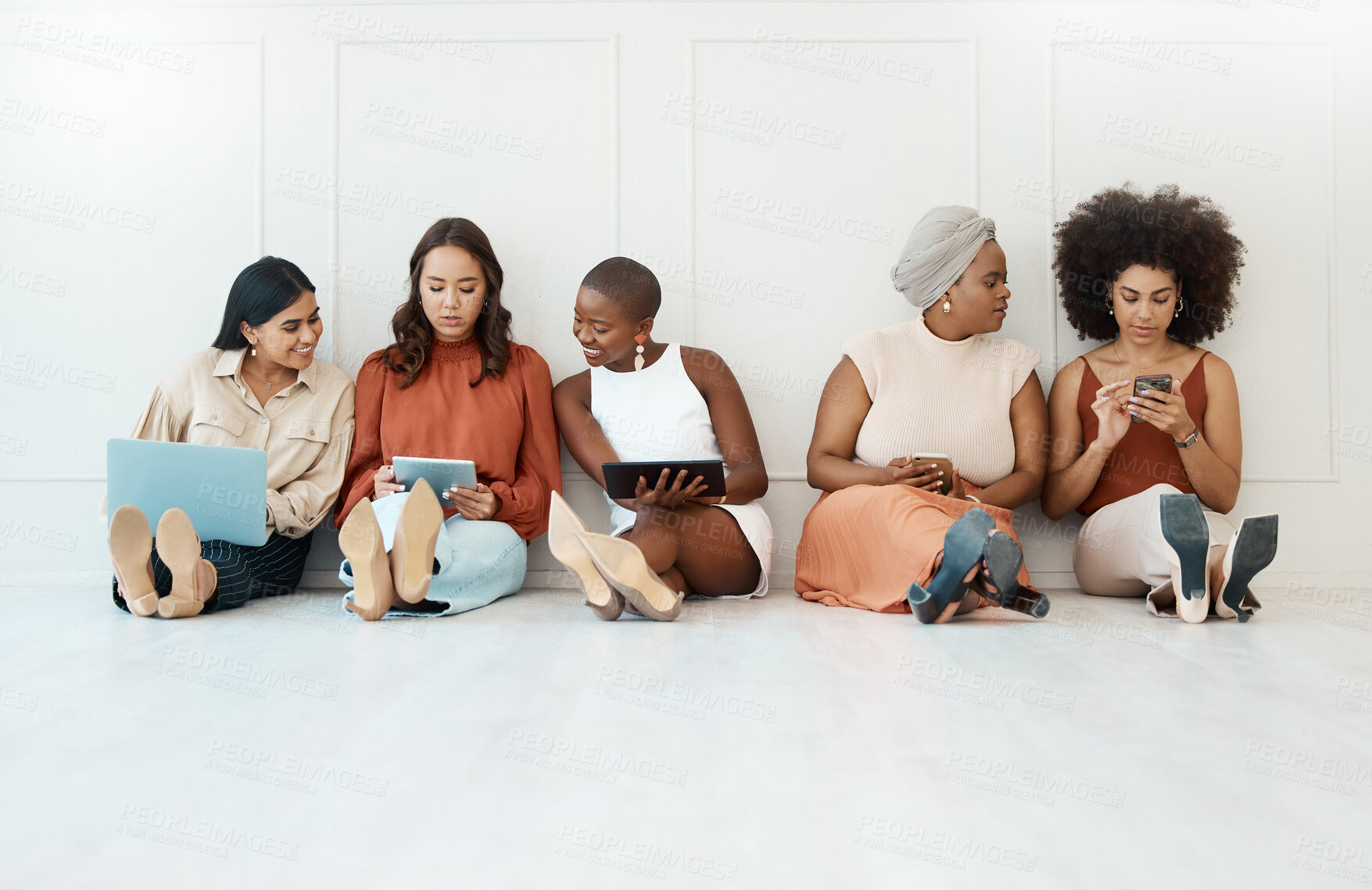 Buy stock photo Group, business and women on the floor, technology or focus for connection, social media or planning. Female employees, coworkers or staff on ground against a wall, office or device for data analysis