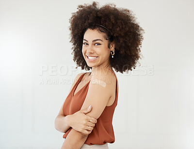 Buy stock photo Woman, smile portrait and covid plaster on arm in studio for injection on medical insurance. Female model happy on white background for healthcare vaccine, safety compliance and medicine mockup space