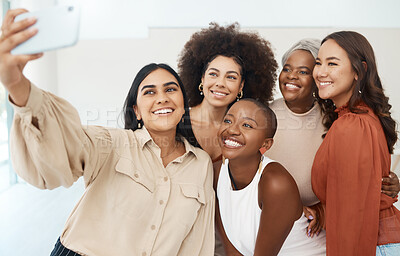 Buy stock photo Happy diverse group of young friends taking a selfie with a phone together. Team of businesswomen taking a photo with a cellphone at work