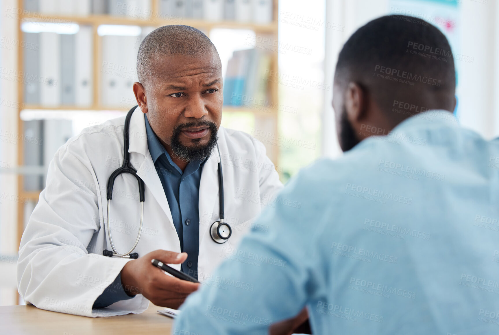Buy stock photo Doctor, serious black man and patient consultation in hospital for talking, checkup or results. Healthcare, medical professional and African person consulting physician for advice or cancer diagnosis