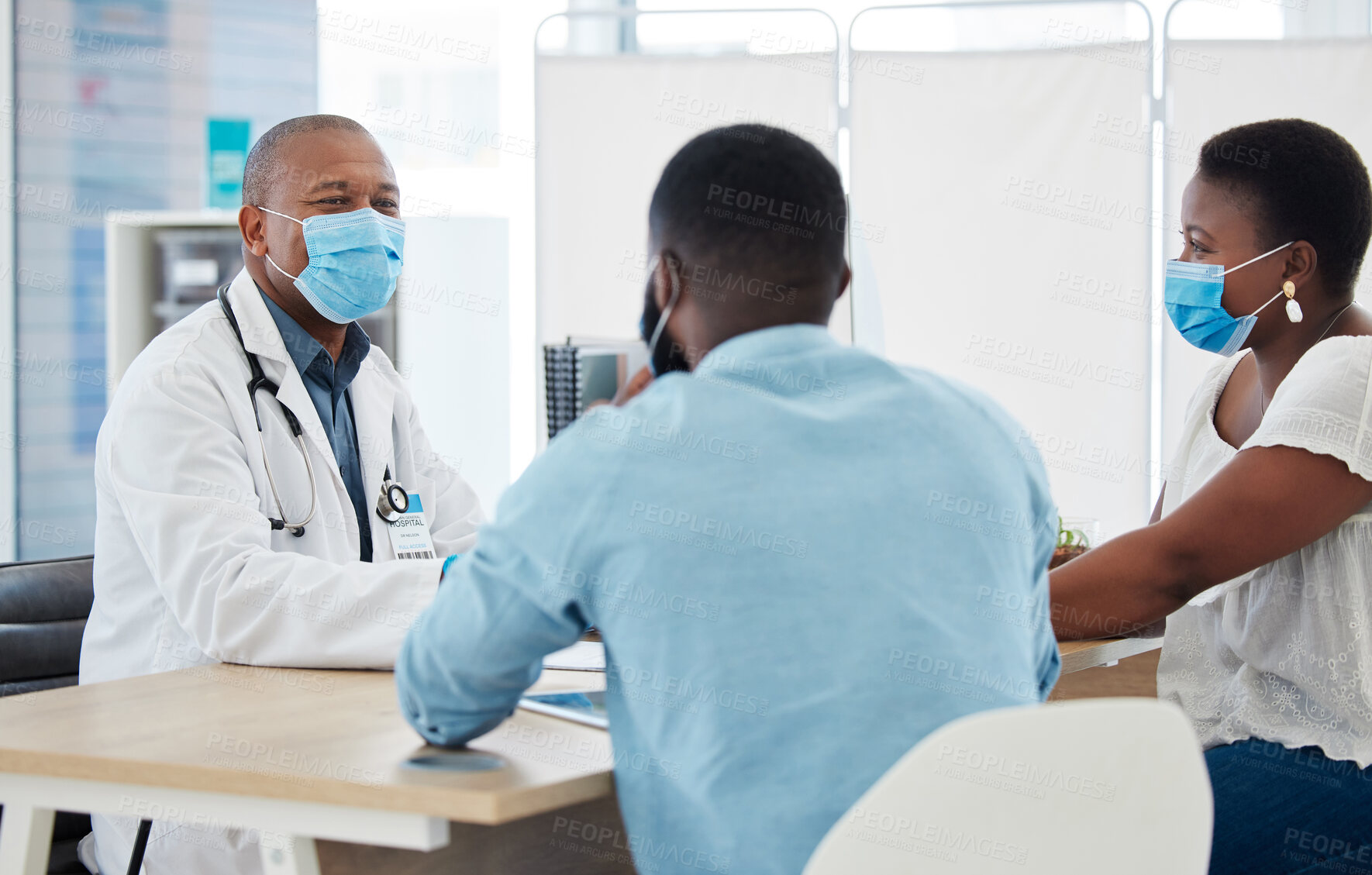 Buy stock photo Covid, healthcare and doctor consulting a black couple in a hospital for wellness, insurance or treatment. Medical, health or trust with a medicine professional talking to a man and woman in a clinic