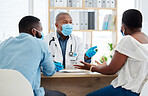 African american couple talking to a doctor about fertility treatment. Professional gp wearing a mask to protect from covid during checkup. Married couple in consult for corona