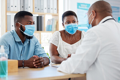 Buy stock photo Covid, healthcare and doctor consulting a married couple in a hospital for insurance or treatment. Medical, health or trust with a medicine professional talking to a man and woman in a clinic