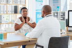 African american woman talking to doctor about sore throat. Doctor in a consult with sick patient. Sick woman talking to her gp about sore glands. Woman in a checkup with her doctor in the clinic
