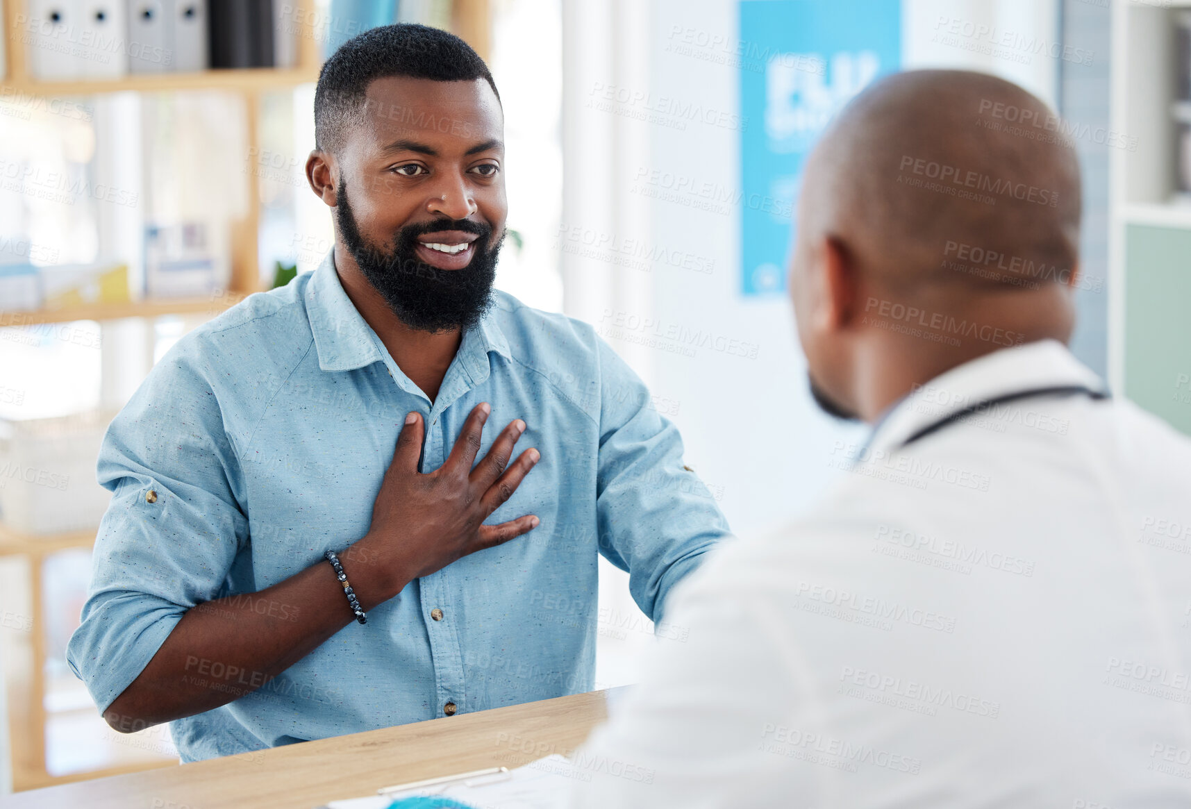 Buy stock photo Doctor, patient and consulting in healthcare checkup, illness or appointment at the hospital. Black man talking to medical professional about chest pain, consultation or health problems at clinic