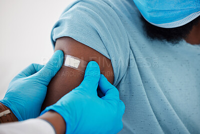 Buy stock photo Doctor, hands and plaster on arm after vaccine with patient for safety, prevention and immunity. Healthcare, covid bandage and black man with medical professional after clinic vaccination in hospital