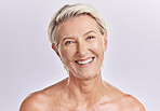 Portrait of a beautiful mature caucasian woman posing topless against pink background copyspace . Happy senior woman with glowing skin. Good skincare and a healthy routine is self care for your skin