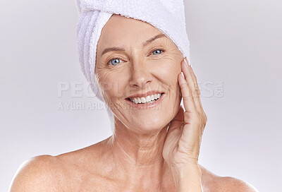 Buy stock photo Portrait of happy woman wear a towel on head after enjoying a refreshing shower and healthy skincare. Senior beauty, cosmetic and face model smile while posing against a grey copy space background