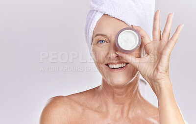 Buy stock photo Portrait, mature or happy woman with face cream, towel or beauty in studio isolated on white background. Dermatology creme, smile or senior lady with clean facial skincare cosmetics or glowing shine