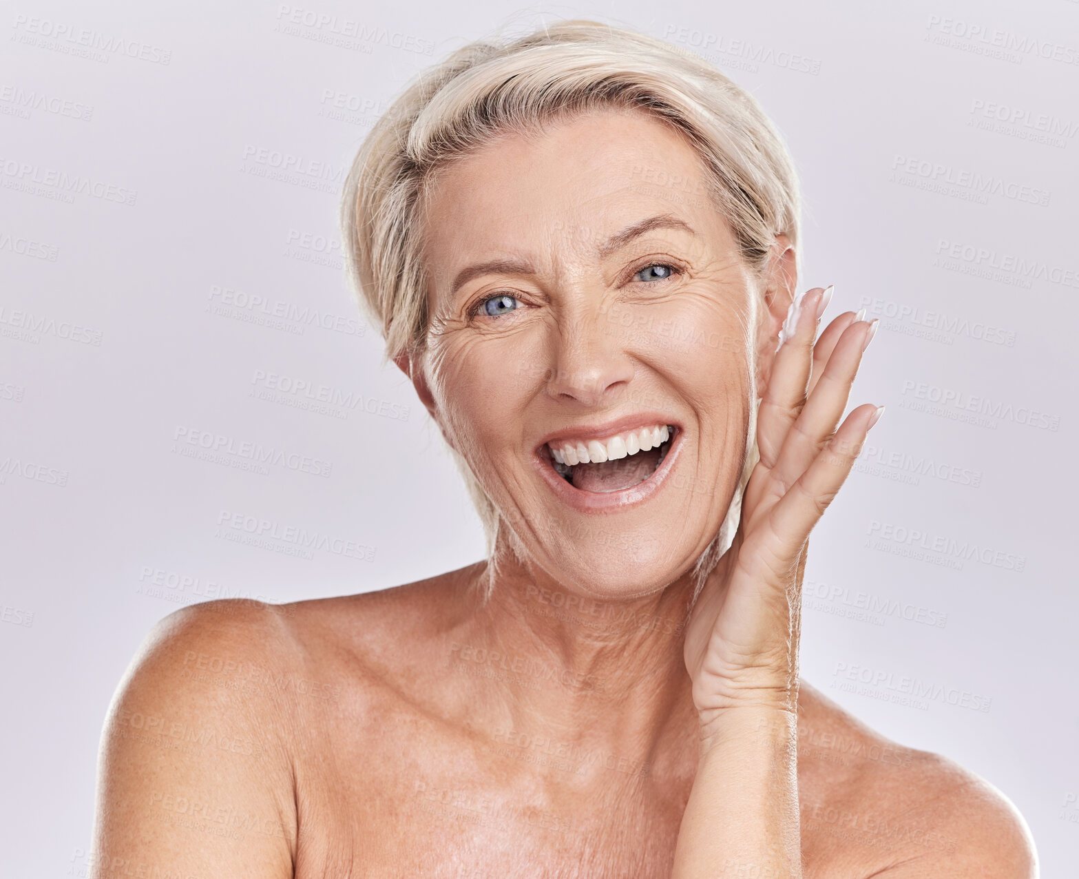 Buy stock photo Portrait of a happy woman showing healthy skin with smile, advertising beauty skin care cosmetics and health wellness on grey studio background. Portrait of face of senior model doing self care