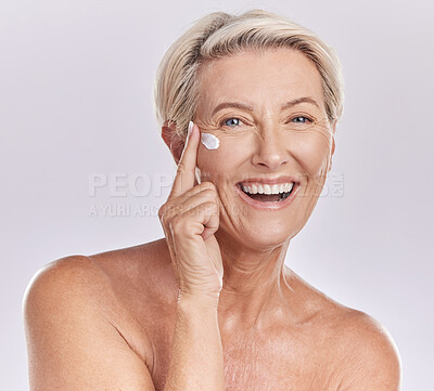 Buy stock photo Skincare, beauty and wellness cream of happy senior woman with smile for skin care on her face in a studio background. Portrait of a mature model lady in beauty, wellness and health and cosmetics.