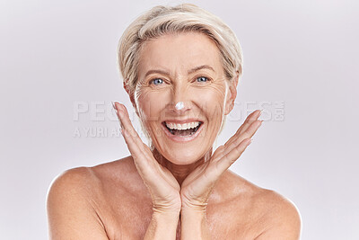 Buy stock photo Skincare, portrait and mature woman with cream on face for anti aging, dermatology and collagen on white background. Facial, happy senior model with lotion or sunscreen in studio with beauty product.