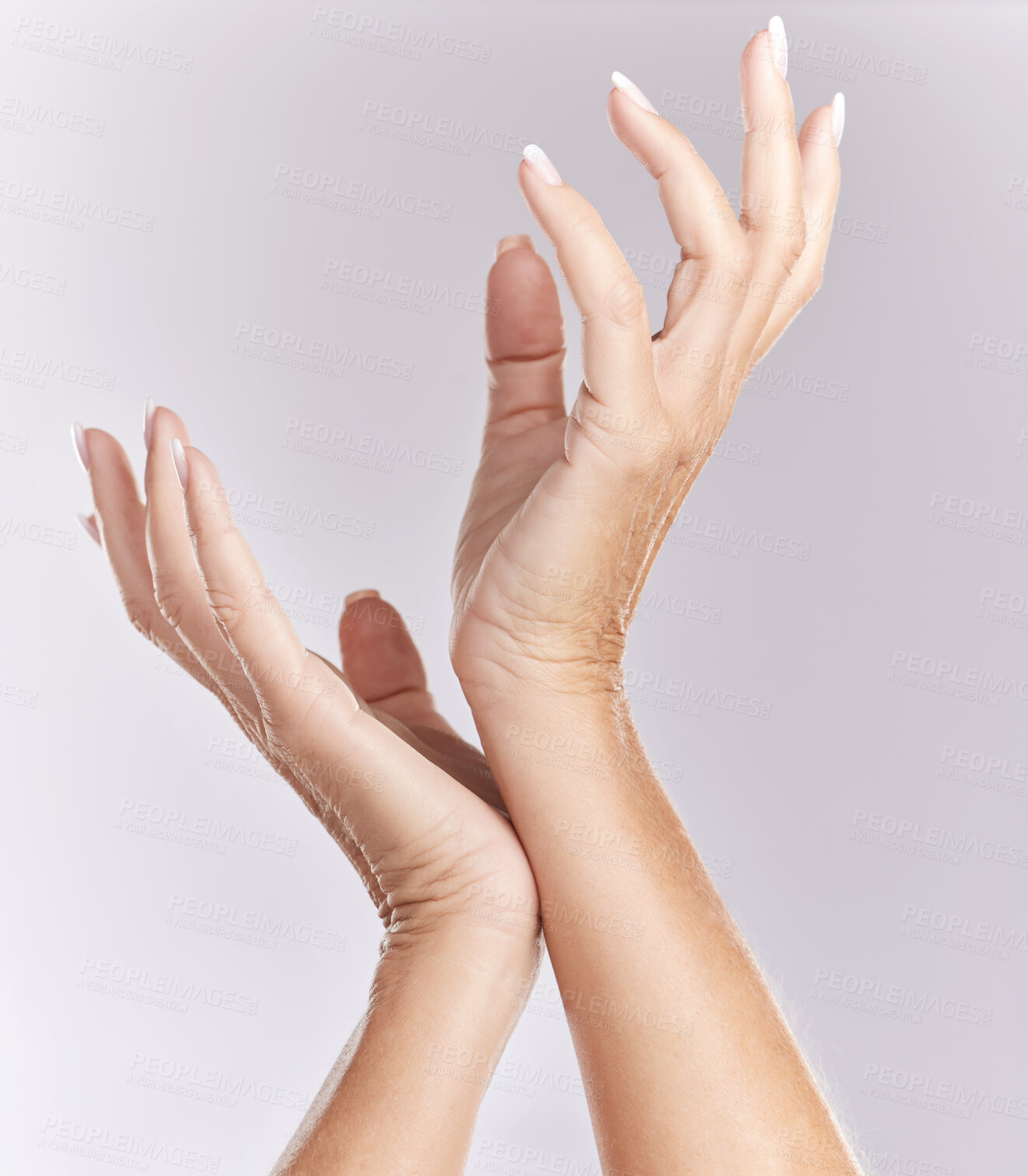 Buy stock photo Soft, manicure hands or beauty treatment closeup of female model palms touching in elegant hand pose isolated on purple studio background. Skincare, nails care or antiaging wrinkle free body part