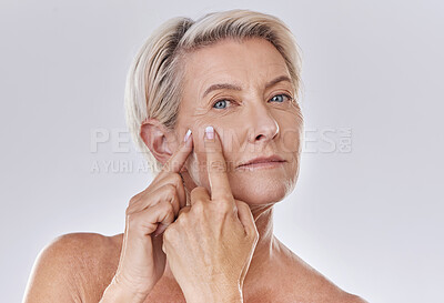 Buy stock photo Acne or pimple popping senior woman while doing a skincare beauty treatment for healthy and clear skin. Portrait of happy old, mature or elderly female squeezing a spot on her face