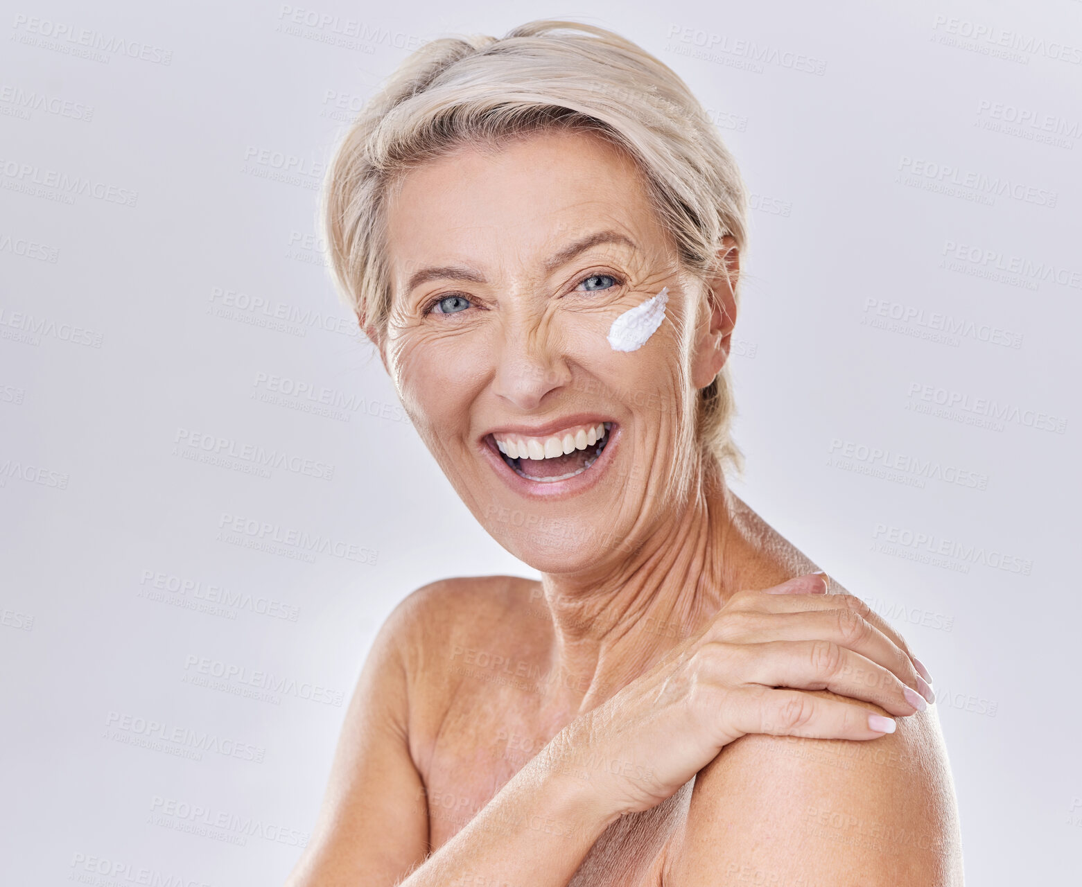 Buy stock photo Happy, laughing and sunscreen on skin care beauty model on studio background. Portrait of mature woman, face and smile with healthy skincare, wellness and safety grooming product against sun damage