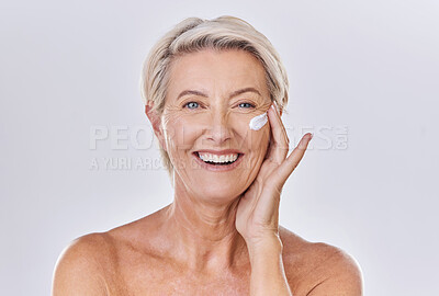 Buy stock photo Portrait, cream on face and beauty with old woman, happy with skincare and dermatology on white background. Sunscreen, moisturizer and glow, female model apply lotion with glass container and skin