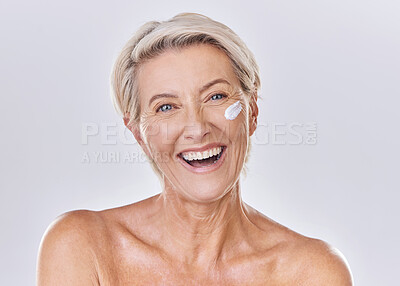 Buy stock photo Senior woman skin care, sunscreen and face wash or cream on skin with happy looking portrait in a studio. Skincare, clean and hygiene of elderly lady for wrinkles free aging or antiaging moisturizer