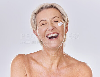 Buy stock photo Sunscreen, lotion and moisturizing senior woman with face cream on skin isolated on studio background. Beauty, fresh and aging lady with wrinkles applying moisturizer for selfcare or skincare routine