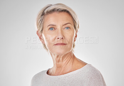 Buy stock photo Beautiful serious mature caucasian woman isolated against a grey background in studio and posing. Portrait of confident senior woman with grey hair. Youthful skin comes from a healthy skincare routine