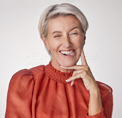 Buy stock photo Comic portrait, quirky model or playful mature woman on gray studio background with funny facial expression, tongue or happy wink face. Silly, classy fashion and elegant stylish beauty or cool person