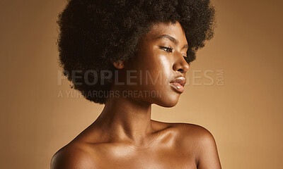 Buy stock photo Confident African American woman with a natural afro posing against brown studio copyspace background. Young beautiful black female model looking trendy, powerful and sensual with smooth glowing skin