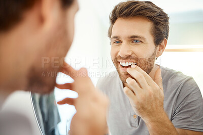 Buy stock photo Teeth, morning routine and mirror with man in bathroom for self care, oral hygiene and dental. Cleaning, smile and health with face of male person at home for beauty, wellness and reflection