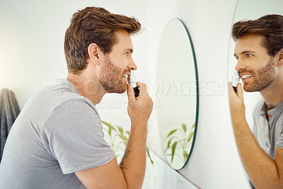 Buy stock photo Mirror, morning and a man nose trimming in the bathroom of a home personal hygiene or skin care. Electric razor, reflection and grooming routine with a young male person in his house for shaving
