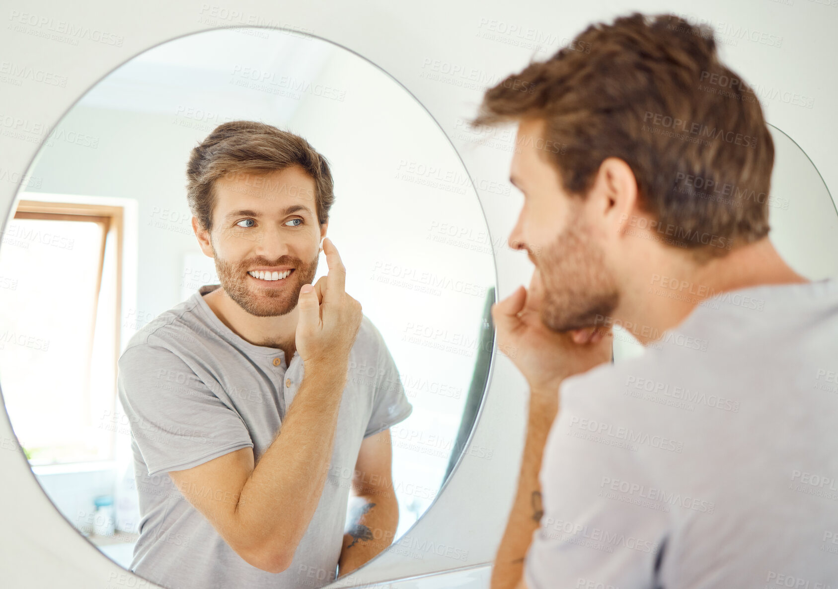 Buy stock photo Bathroom, mirror and happy man with skincare cream for self care, skin hydration or home beauty treatment. Face cosmetics, dermatology smile or reflection of person with morning sunscreen application