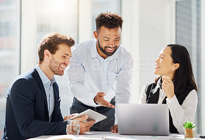 Group of happy young diverse colleagues working together on corporate plans in an office boardroom. Mixed race businessman pointing to laptop while explaining ideas to his caucasian and asian coworkers