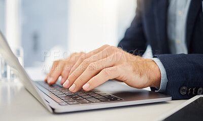Closeup of caucasian businessman typing on a laptop keyboard in an office. Hands of one entrepreneur pressing buttons to send email and browse the internet to complete deadlines. Lawyer compiling legal reports online