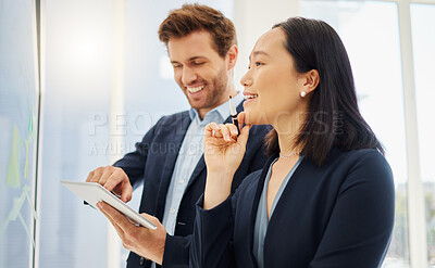 Confident asian businesswoman thinking of ideas with her hand on her chin while planning a project with a caucasian businessman using a digital tablet. Two young colleagues brainstorming together on a glass wall in an office
