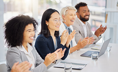 Happy young asian businesswoman clapping hands for presentation during a meeting in an office boardroom with colleagues. Diverse group of smiling businesspeople sitting in a row on a panel as audience and applauding after an inspiring and motivating talk