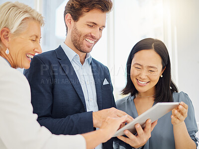 Group of diverse colleagues working together on a digital tablet in an office. Confident smiling staff discussing corporate plans and ideas while using apps on device