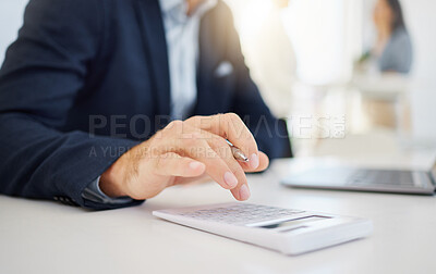 Closeup of one caucasian businessman using a calculator while working on a laptop in an office. Hands of accountant doing financial planning and online banking. Budgeting for expenses and paying tax. Broker investing and saving while trading