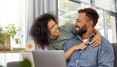 Buy stock photo Mixed race couple smiling while using a laptop together at home. Cheerful hispanic boyfriend and girlfriend laughing while relaxing and using a laptop in the lounge at home