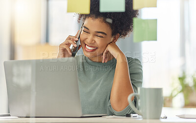 Buy stock photo Happy mixed race woman on a call with her cellphone while working on a laptop sitting at a table at home. Cheerful hispanic female with a curly afro laughing while talking on the phone alone in the lounge at home