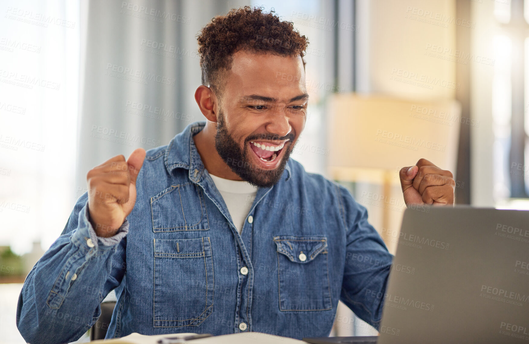 Buy stock photo Excited businessman working from home on his laptop cheering. Young businessman doing virtual remote work from home. Entrepreneur cheering after his luck with work. Freelance worker at home