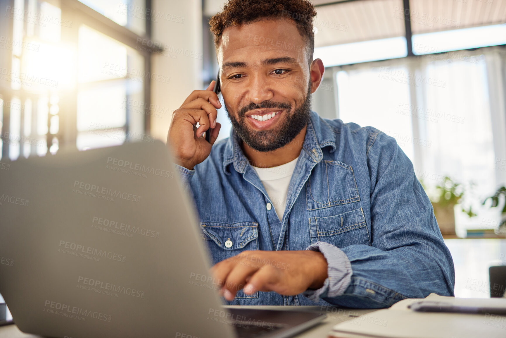 Buy stock photo Smiling entrepreneur making a call on his cellphone working from home. Freelance businessman working on his laptop at home. Always connected to the internet as an entrepreneur